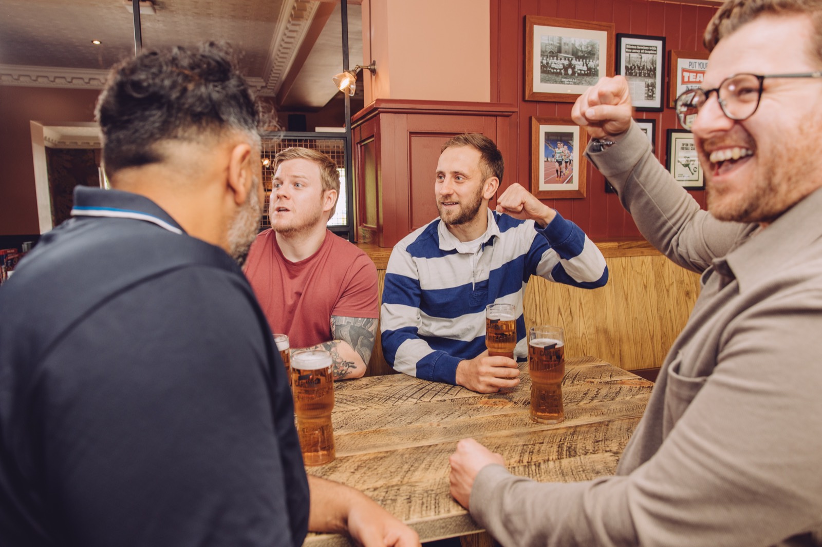 Friends gathered around a table in a Grandstand pub