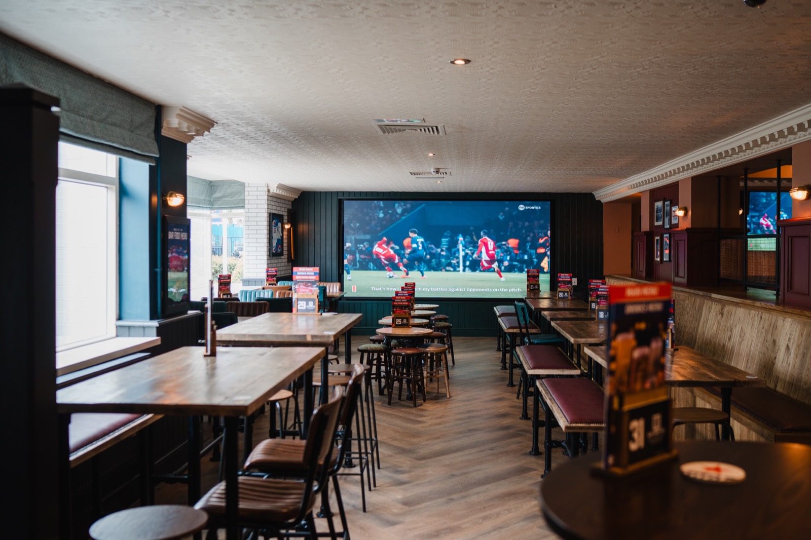 A Grandstand pub interior designed around a large sports screen